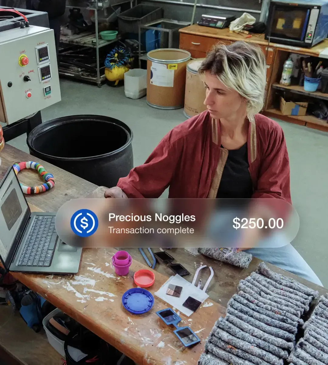 Image of a person working with a UI alert bubble showing a transaction was completed for Precious Noggles